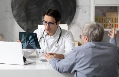 A doctor discussing an arthritis diagnosis with a patient. Image by Vitaliy Abbasov via Shutterstock.